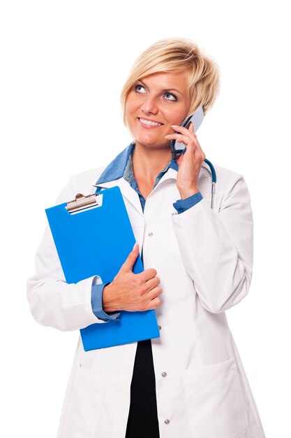 Portrait of busy young female doctor