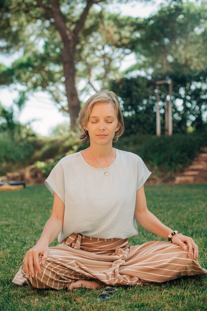 Portrait of calm beautiful young woman meditating