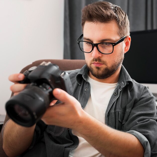 Portrait of casual male checking out professional camera