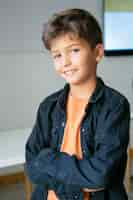 Free photo portrait of caucasian schoolboy with folded hands