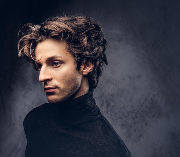Free photo portrait of a charismatic sensual male in black sweater. creative personality.