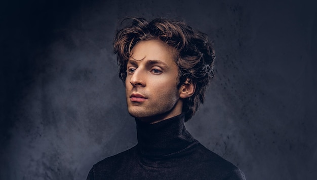 Free photo portrait of a charismatic sensual male in black sweater. creative personality.