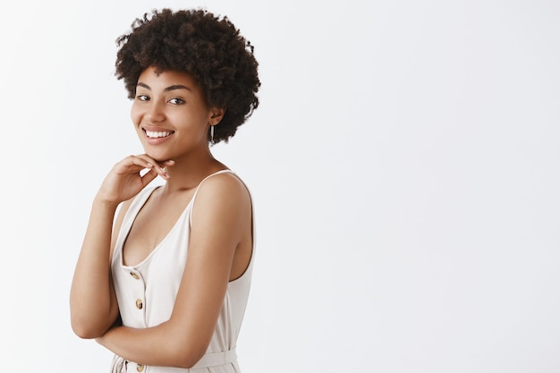 Portrait of charming beautiful and healthy African American with pure skin and cute afro hairstyle