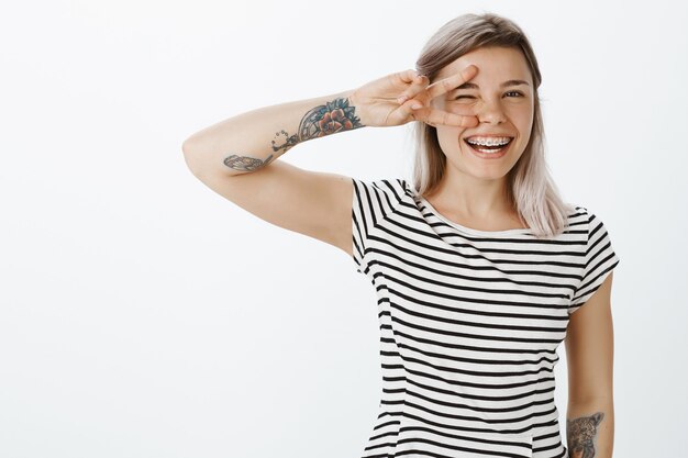 Portrait of charming blonde girl posing in the studio