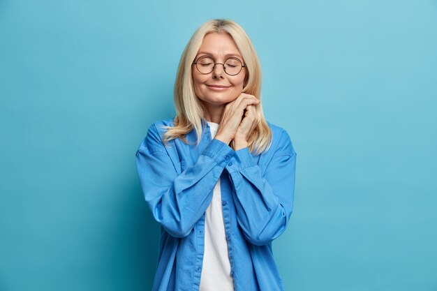 Portrait of charming middle aged attractive woman with blonde hair