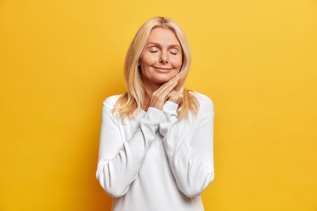 Portrait of charming middle aged attractive woman with blonde hair