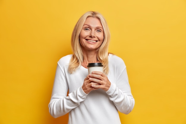 Portrait of charming middle aged attractive woman with blonde hair