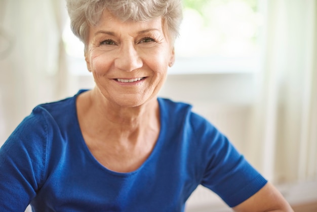 Portrait of cheerful and attractive senior woman