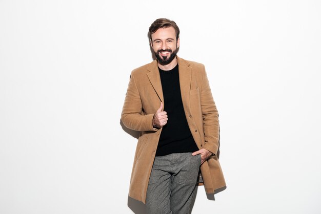 Portrait of a cheerful bearded man dressed in a coat