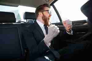 Free photo portrait of cheerful businessman celebrating his success