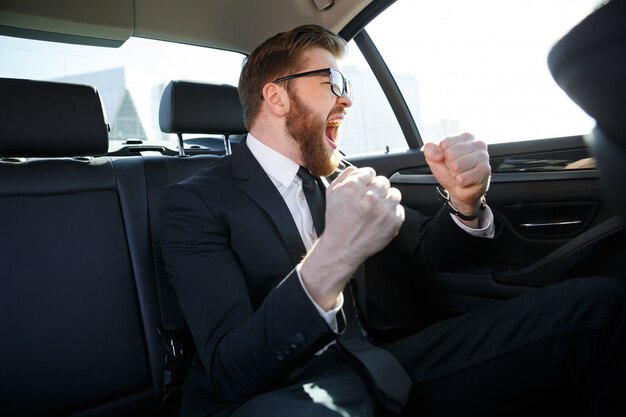 Portrait of cheerful businessman celebrating his success