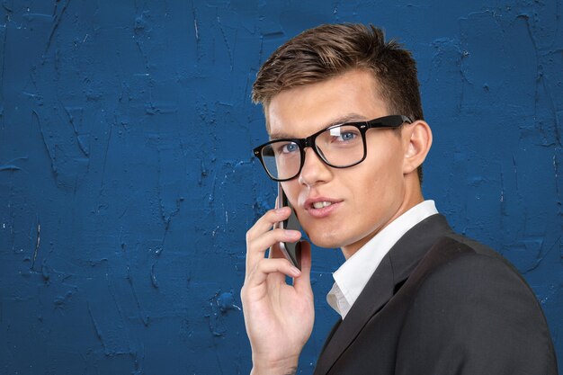 Portrait of a cheerful businessman talking on the phone