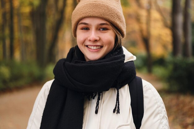 Portrait of cheerful casual girl happily looking in camera outdoor