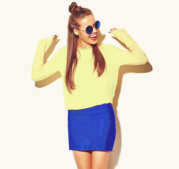 portrait of cheerful fashion hipster girl going crazy  in casual colorful hipster yellow summer clothes with red lips 