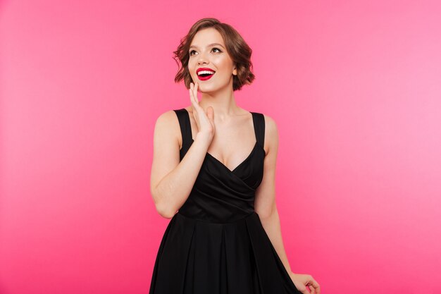 Portrait of a cheerful girl dressed in black dress