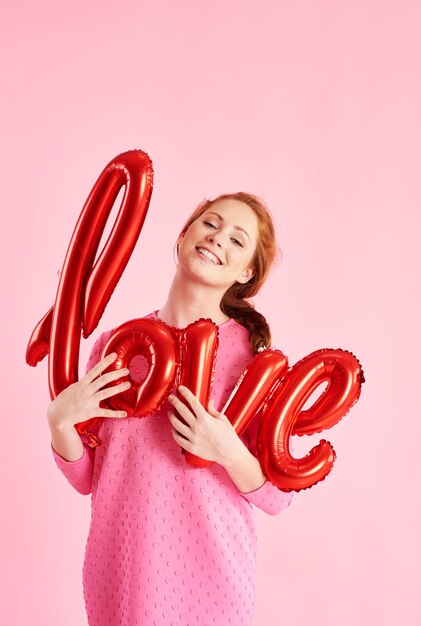 Portrait of cheerful girl holding a balloon at studio shot