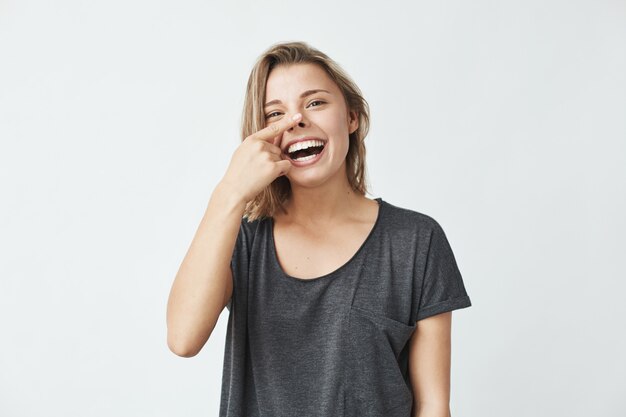 Portrait of cheerful happy beautiful girl smiling making funny face .