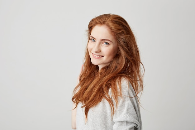 Portrait of cheerful happy beautiful girl with foxy hair smiling .