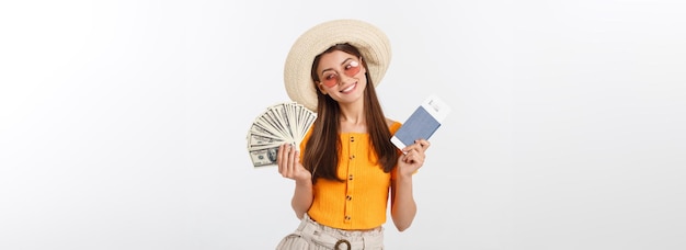 Portrait of cheerful happy laughing girl with hat on head having money fan and passport with tickets