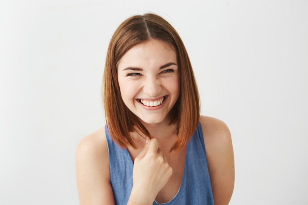 Portrait of cheerful happy young beautiful girl laughing smiling .