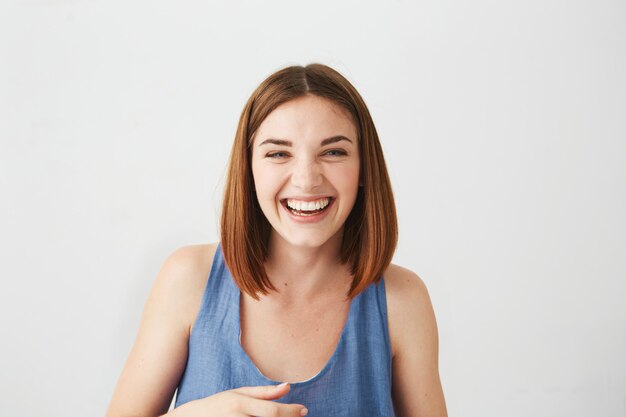 Portrait of cheerful happy young beautiful girl laughing smiling .