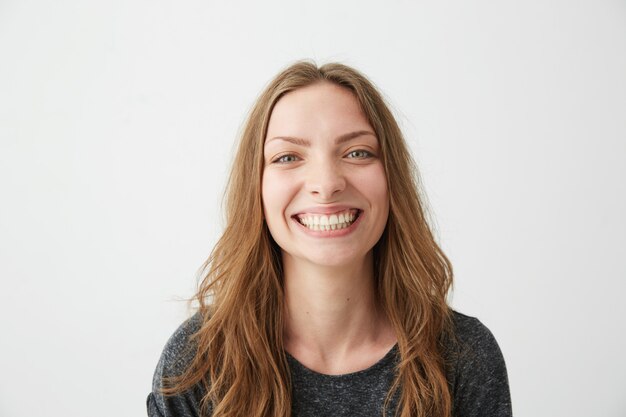 Portrait of cheerful happy young pretty girl laughing smiling .