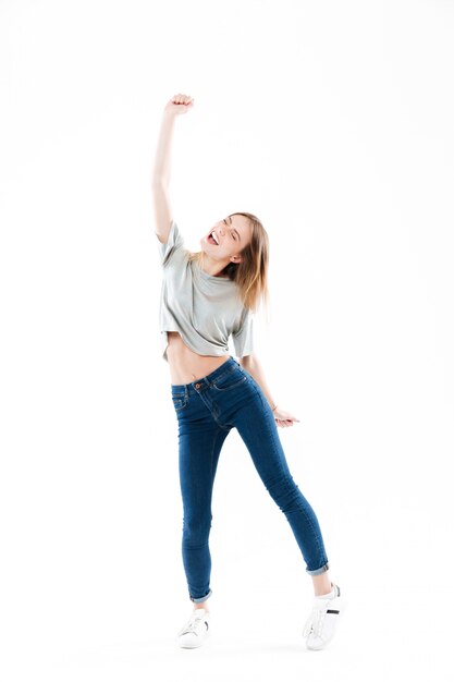 Portrait of a cheerful happy young woman celebrating success