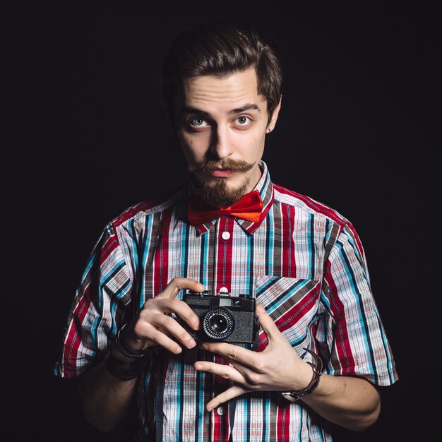 Portrait of a cheerful photographer in studio