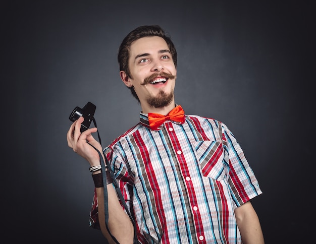 Portrait of a cheerful photographer in studio