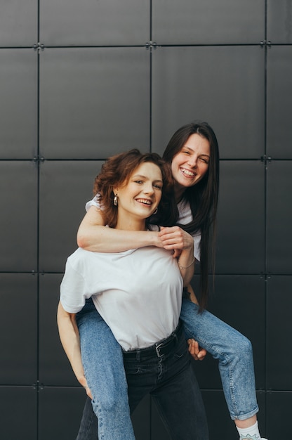 Portrait of cheerful two girlfriends having fun