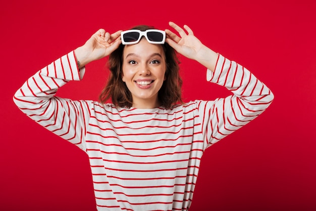 Portrait of a cheerful woman in sunglasses posing