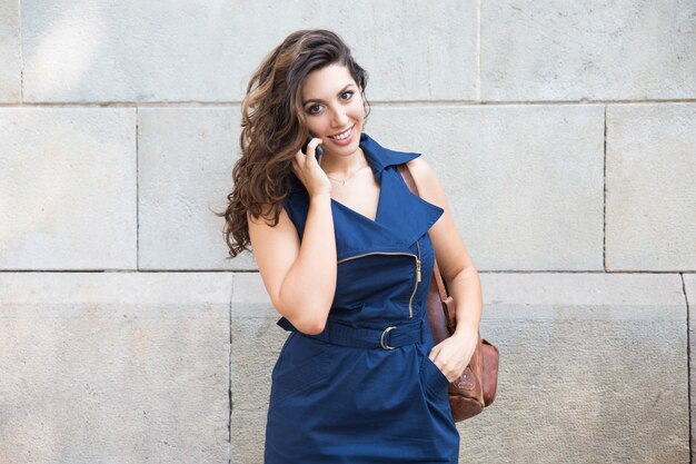 Portrait of cheerful woman talking on cellphone