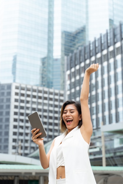 Portrait cheerful working woman with successful in city