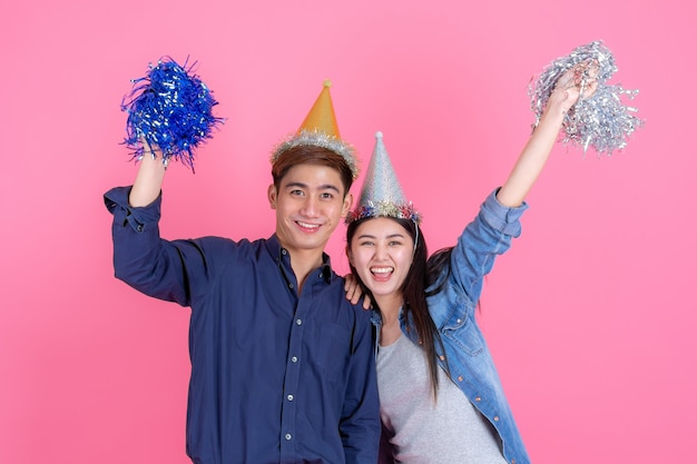 Portrait cheerful young couple with party prop