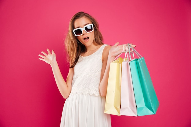 Portrait of a cheerful young girl in sunglasses