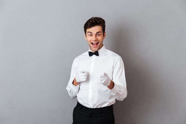 Portrait of a cheerful young male waiter