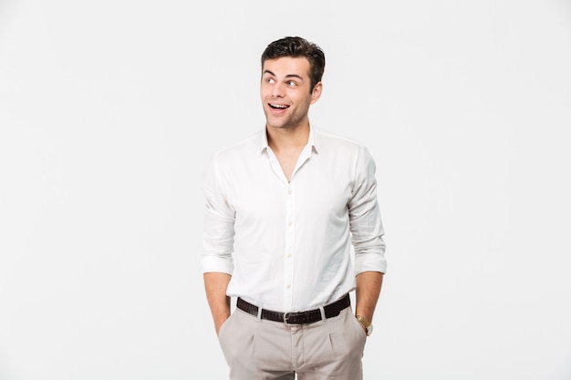 Portrait of a cheerful young man in white shirt