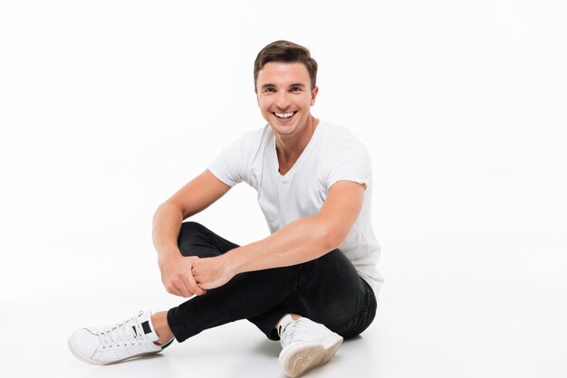 Portrait of a cheerful young man in white t-shirt