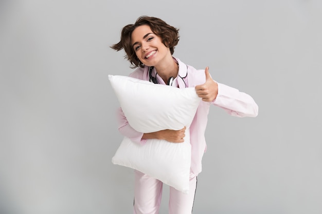 Portrait of a cheerful young woman in pajamas