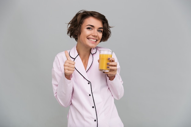 Portrait of a cheerful young woman in pajamas