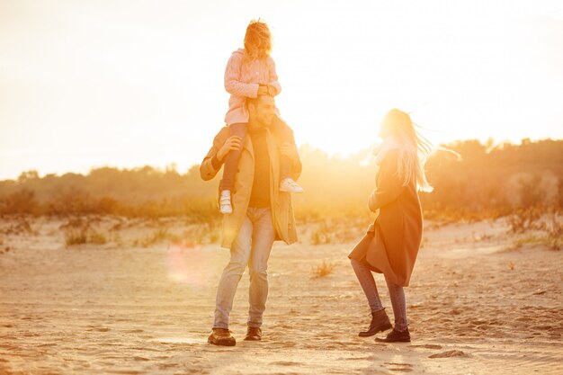 Portrait of a cheery family with a little daughter