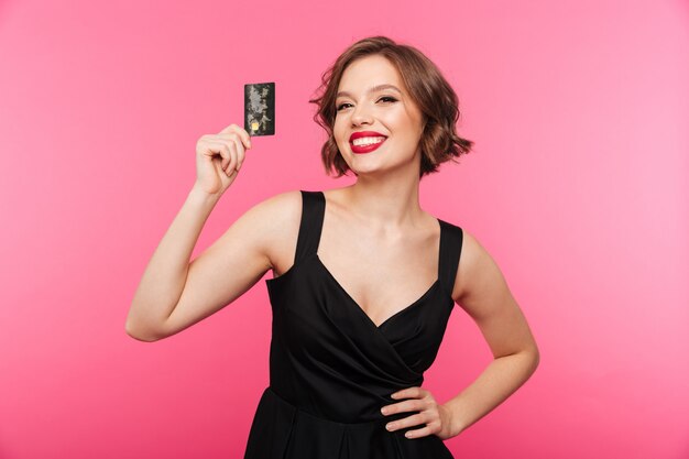 Portrait of a cheery girl dressed in black dress