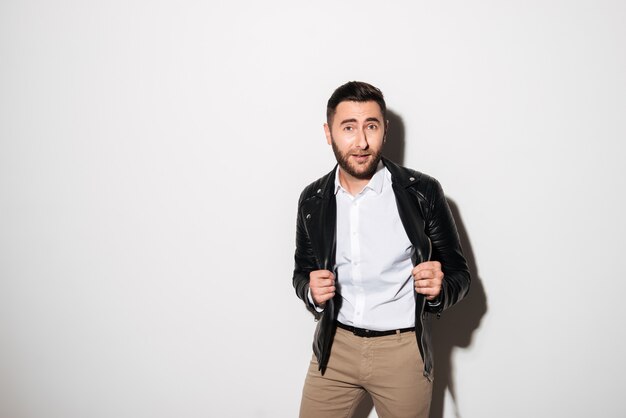 Portrait of a cheery young man in jacket posing