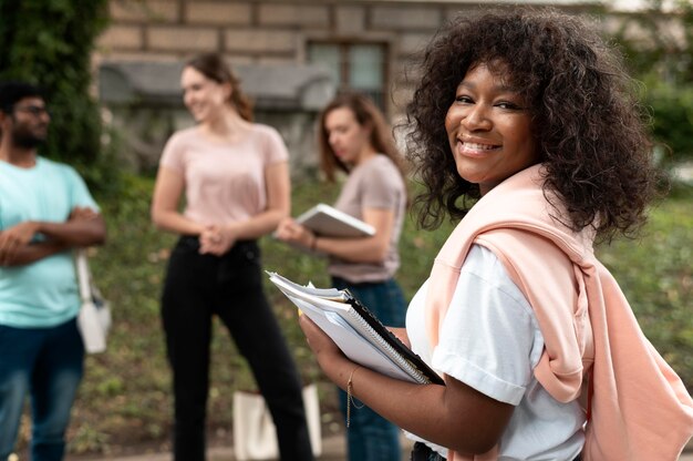 Portrait of college girl in front of her mates