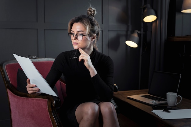 Portrait of confident businesswoman checking papers