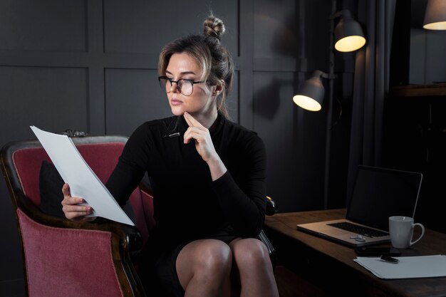 Portrait of confident businesswoman checking papers
