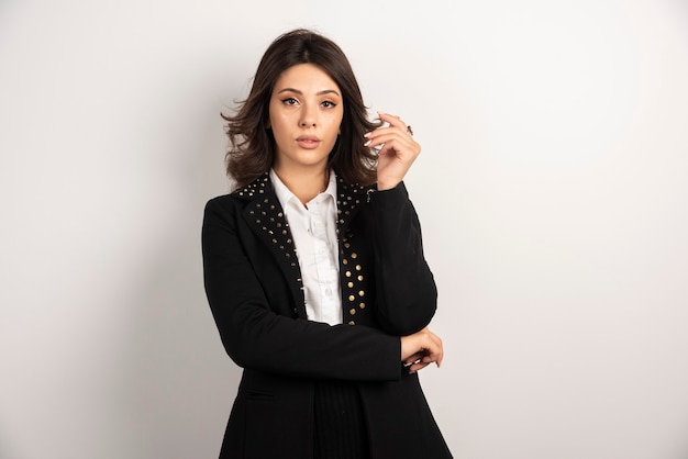 Portrait of confident businesswoman posing on white.