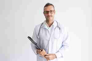 Free photo portrait of confident doctor wearing glasses holding folder.