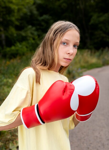 Portrait of confident girl with boxing gloves