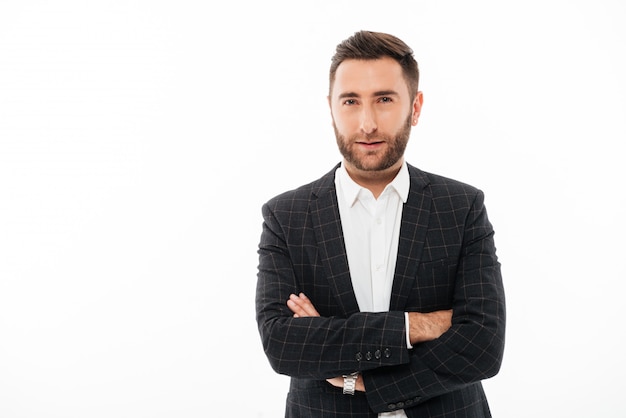 Portrait of a confident handsome man standing with arms folded